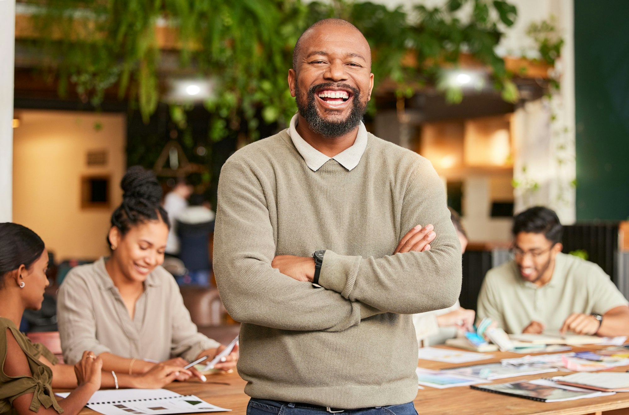 Black man, portrait smile and arms crossed in leadership for meeting, teamwork or brainstorming at