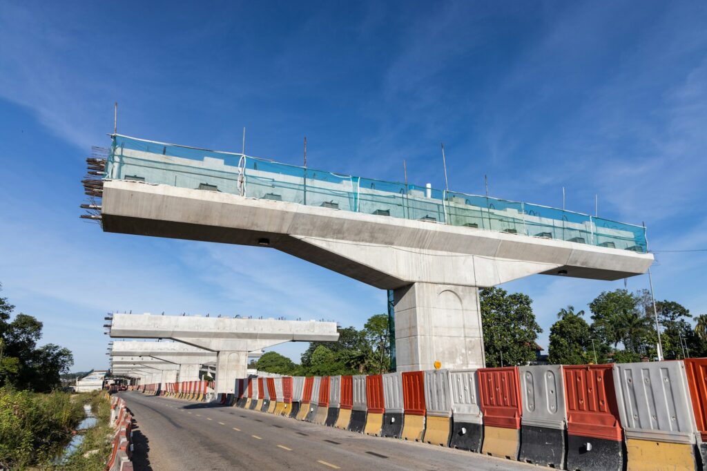 Construction of highway overpass bridge infrastructure in progress with morning sun rays