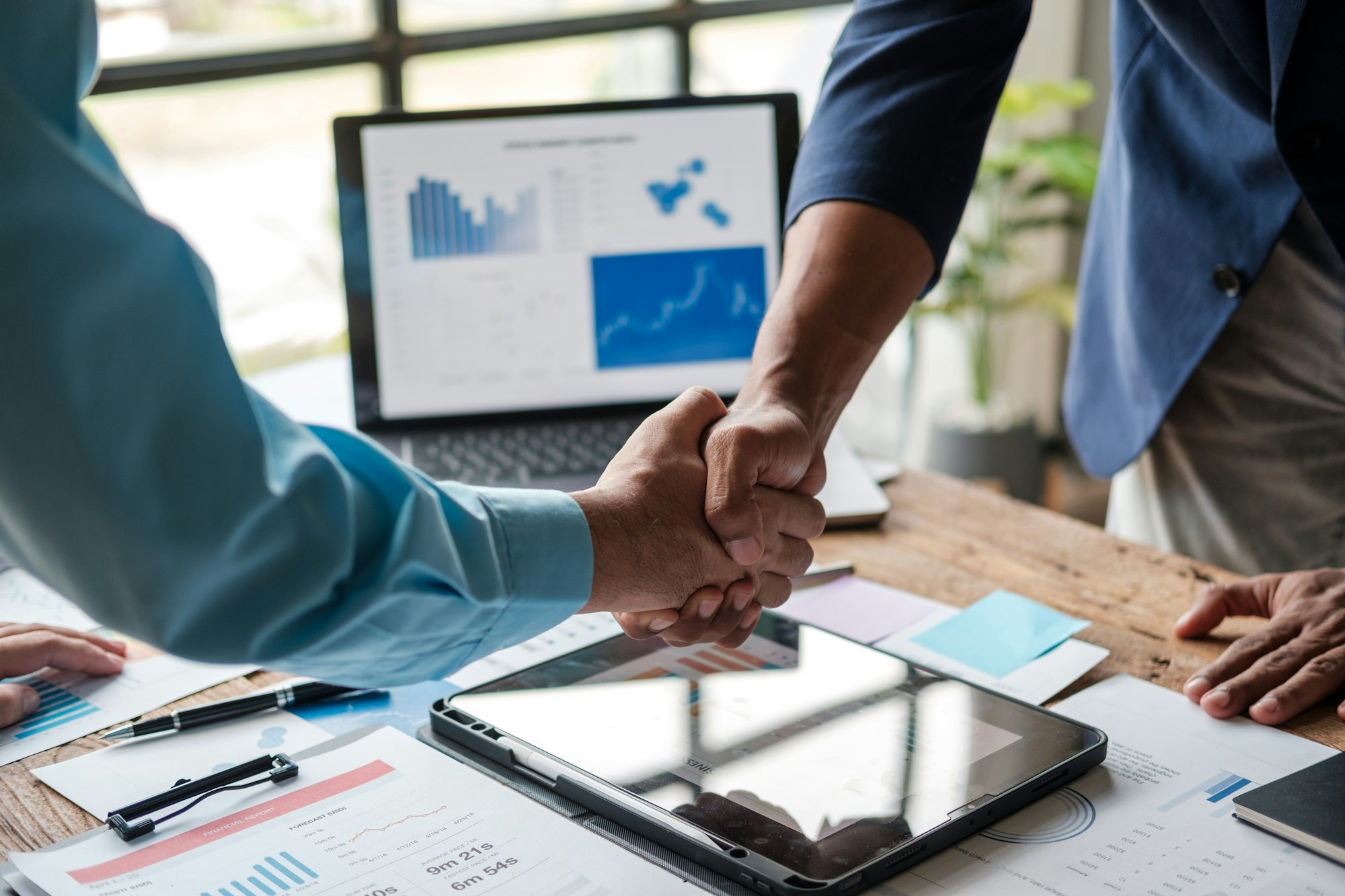 Two businessman shake hand with partner to celebration partnership and business deal concept